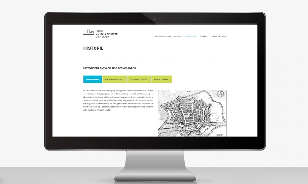 Computerbildschirm zeigt eine Website zur historischen Entwicklung des Geländes des Projekts Güterbahnhof Lippstadt mit Text und einer alten Karte.